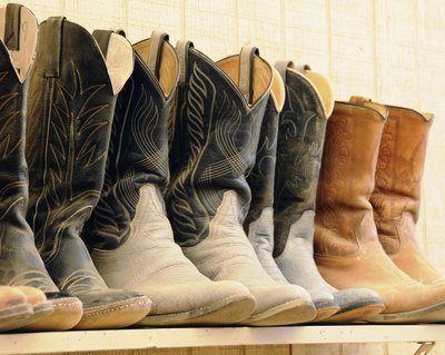Shelf of dusty cowboy boots