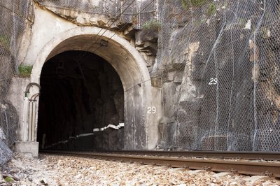 Railroad track going into tunnel