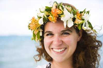 Young bride wearing floral lei crown at bridal shower.