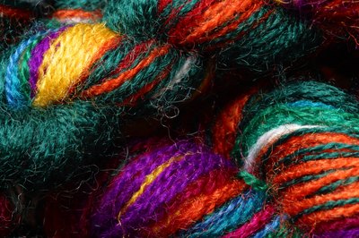 Fill the hamper with different colored, good-quality yarn, knitting needles and book of new patterns.