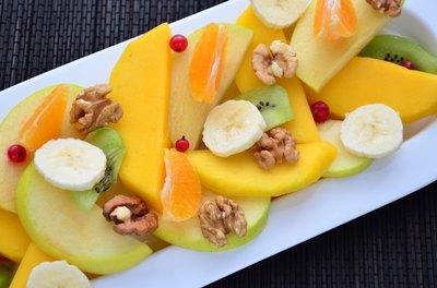 A fresh fruit plate sprinkled with walnuts