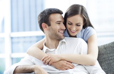 Smiling newlywed couple in apartment