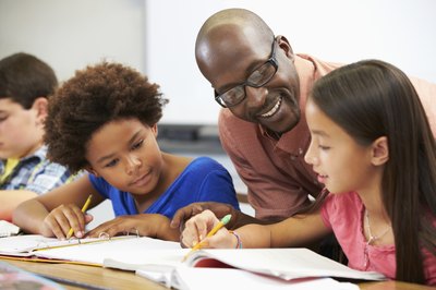 teacher working with students