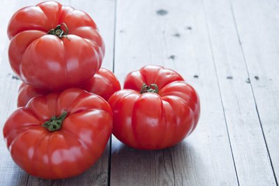 Brandywine tomatoes on planks of wood.