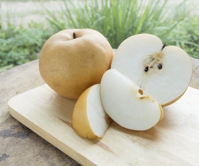 Sliced Asian pear on cutting board.