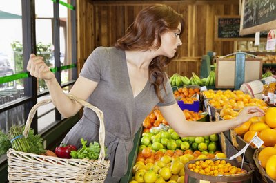 Woman shopping for fresh fruit and vegetables.