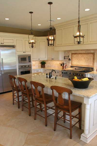 A new custom kitchen with modern appliances and lighting.