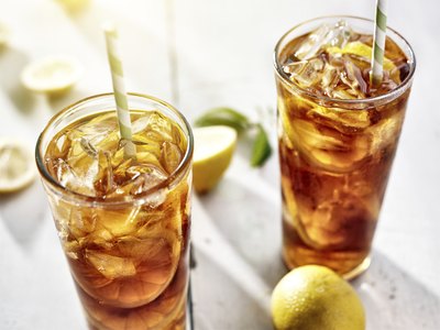 Two tall glasses of iced tea.