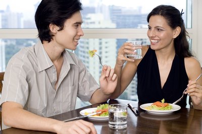 Young couple eating salads together