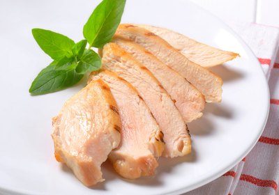 Slices of lean, grilled chicken on a plate.