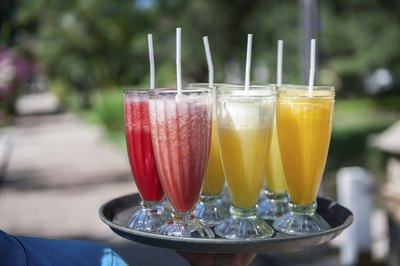 An assortment of fruity cocktails on a tray.