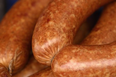 Hemera Technologies/AbleStock.com/Getty Images He may beg, but sausage is a risky meat for your dog.