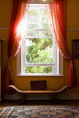 Jupiterimages/Goodshoot/Getty Images Window treatments can cause choking and injury to pets.