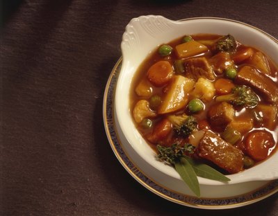 Jupiterimages/Comstock/Getty Images A hearty meat stew packed with vegetables is healthy for you and your dog.