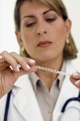 Medioimages/Photodisc/Photodisc/Getty Images Your veterinarian will treat the underlying cause of your dog's fever.