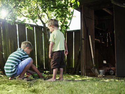 Ryan McVay/Photodisc/Getty Images Burying your dog at home allows the entire family to participate.