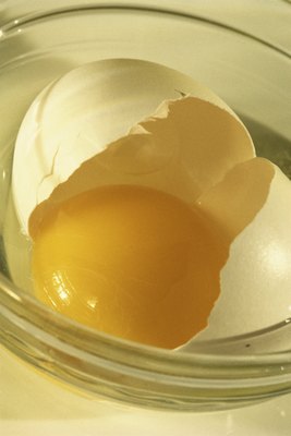 Jupiterimages/Photos.com/Getty Images Those yolks contain lots of healthy amino acids for your pup.