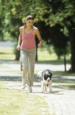 Stockbyte/Stockbyte/Getty Images Your dog should match your pace instead of rushing ahead of you.