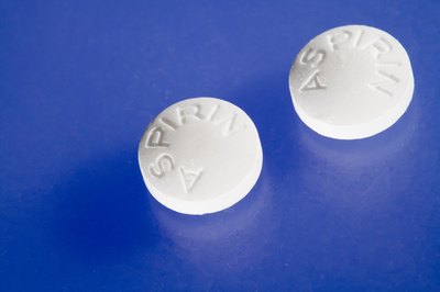 Comstock Images/Comstock/Getty Images Aspirin has side effects that can make your dog sick.