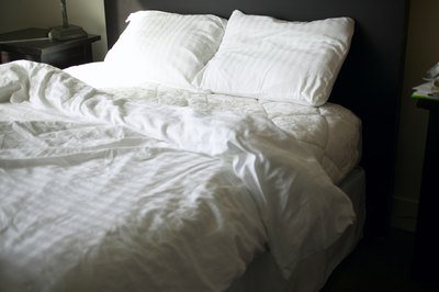 Jupiterimages/Photos.com/Getty Images Turn your old bed pillows into a special bed for your favorite pooch.