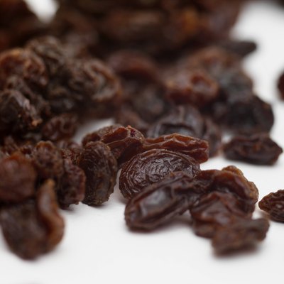 George Doyle/Stockbyte/Getty Images Never allow your pooch near any food that includes raisins or grapes.