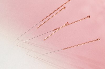 Comstock/Comstock/Getty Images Acupuncture involves the use of needles to help calm your pooch.