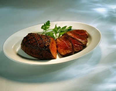 Jupiterimages/Comstock/Getty Images Cooked properly, meat can be a healthy part of a dog's diet.