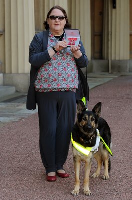 WPA Pool/Getty Images Entertainment/Getty Images Blind composer Jacqueline Clifton and her guide dog Henna after she received her Member of the British Empire medal Oct. 18, 2011 at Buckingham Palace.