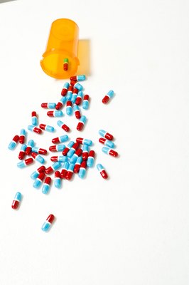 Jupiterimages/Stockbyte/Getty Images Keep all pills in a secure container that is well out of your pet's reach.