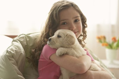 Chris Amaral/Digital Vision/Getty Images Instruct children that dogs need to remain calm during their recovery.