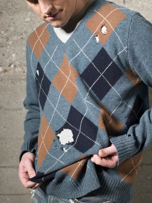 Stewart Sutton/Digital Vision/Getty Images Recycle that old, worn-out sweater to make clothes for your puppy.