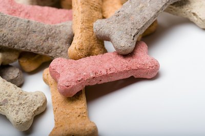 Jupiterimages/liquidlibrary/Getty Images Cookies and treats made with traditional flour give some dogs tummy aches.