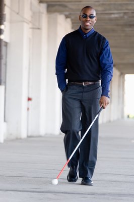 Jupiterimages/Photos.com/Getty Images Service dogs help keep visually impaired persons safe.