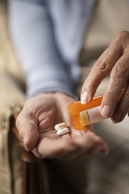 Thomas Northcut/Digital Vision/Getty Images Keep all medicine in a secure container well out of your dog's reach.