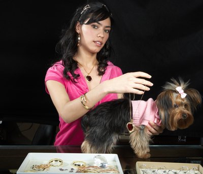 Baerbel Schmidt/Photodisc/Getty Images Pampering your dog doesn't necessarily mean putting on some jewels.