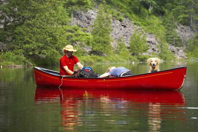 Jupiterimages/Photos.com/Getty Images You can train a dog for a boat of any size.