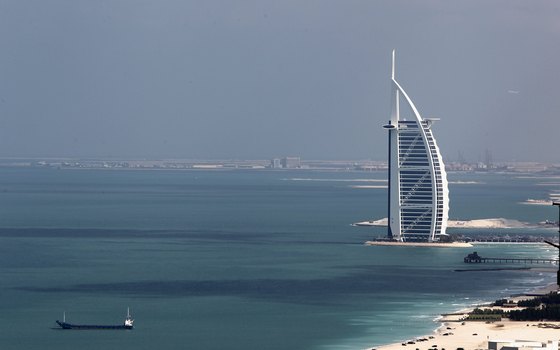 Burj al Arab stands on a man-made island connected to the mainland.