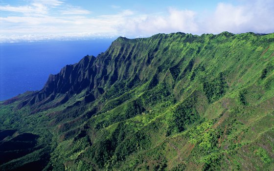 Backpackers on Kauai's Na Pali Coast hug incredibly sheer cliffs.