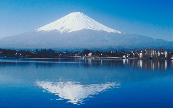 Mount Fuji is reflected in the water of Lake Kawaguchiko.