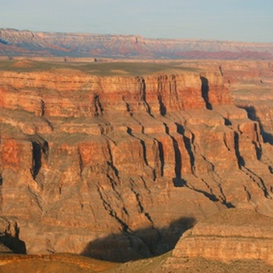 The setting sun intensifies the red rock of the Grand Canyon.