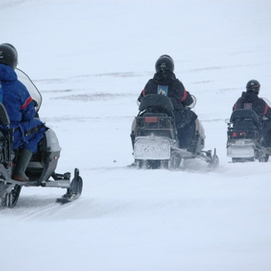 Alaskan snowmobile tours explore the vast, snow-covered wilderness of Alaska.