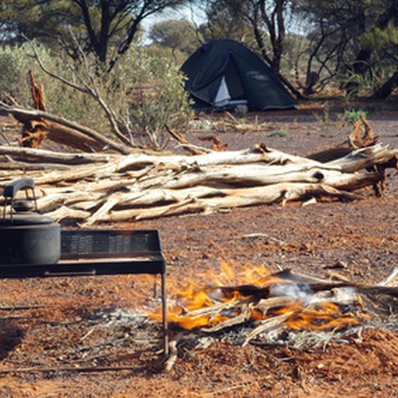 A hot meal being prepared by campfire.