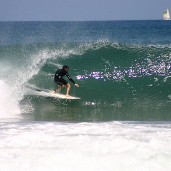 A surfer emerging from a pipe.