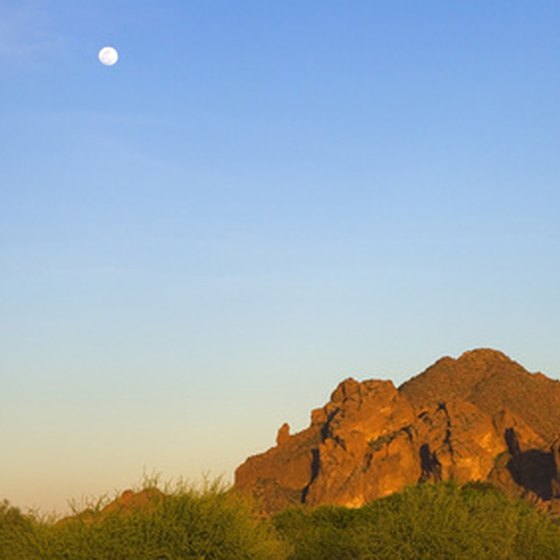Red rock Camelback Mountain beckons climbers to scramble its technically challenging trails in mid-Phoenix.