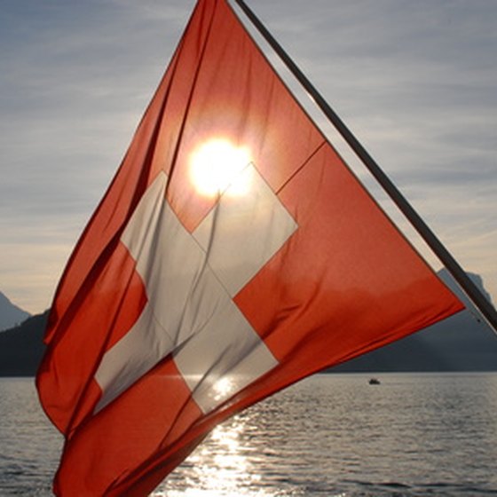 The Swiss flag with an Alpine backdrop