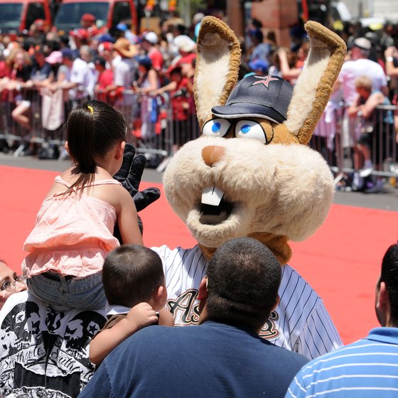 A Houston Astros mascot gives a high-five during a 2011 parade in Phoenix honoring baseball's All-Stars.