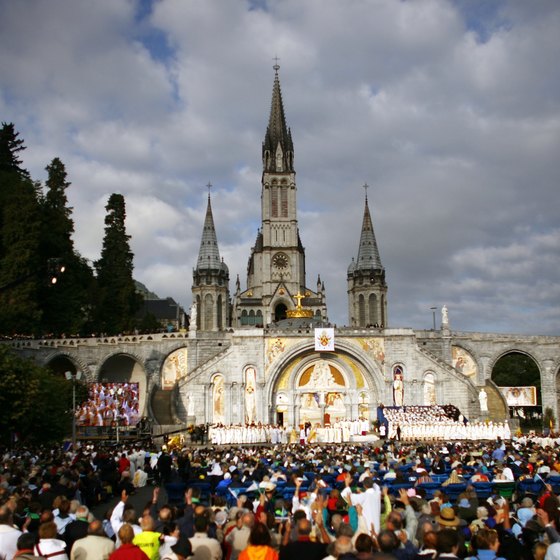 The faithful visist Lourdes, France, where Saint Bernadette saw an apparation of the Virgn Mary.