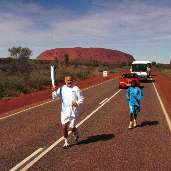 Uluru as the background for runners with the 2000 Olympic torch