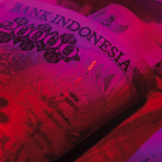 Bali's banks use ultraviolet light to check for counterfeit bills.