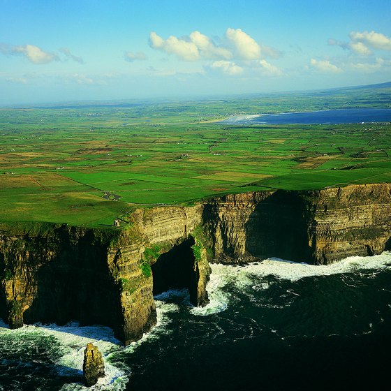 Daring adventurers can stand at the edge of the Cliffs of Moher for ocean views.